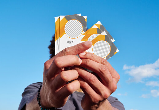 Hands Hold Blank Business Cards in Blue Sky
