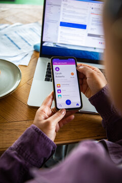 Person using mobile banking app at home office desk