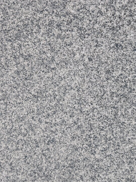 High-resolution full-frame background texture of a natural gray granite stone surface with a dense speckled mineral pattern
