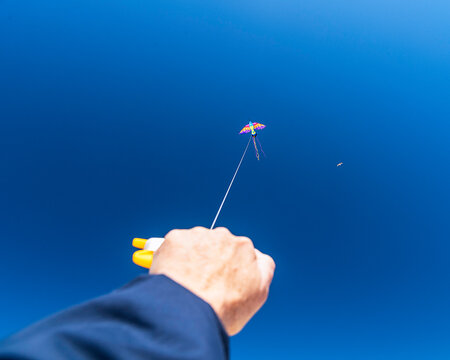 May 13, 2026, Lompoc, CA, USA: A POV of a hand holding a kite flying against a blue sky on Jalama Beach in Lompoc, CA.