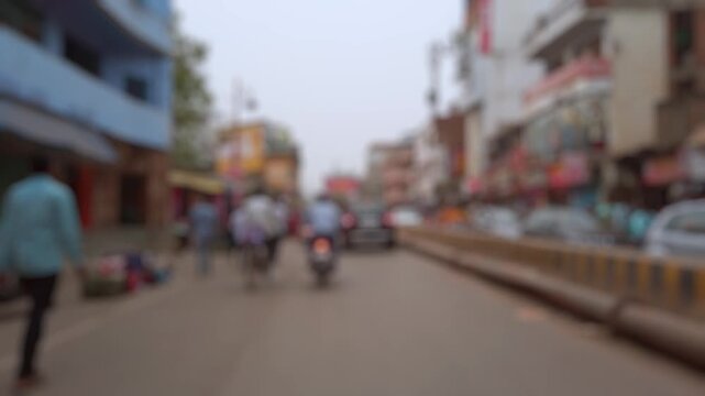 Bokeh view of road traffic on the crowded streets of Varanasi, India. Blurred background footage.