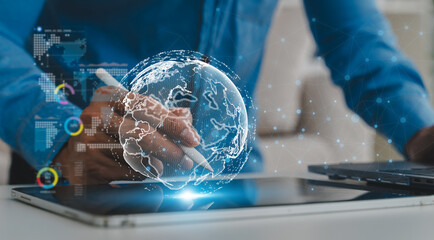 Obraz premium Businessman hand using stylus on tablet with global network graphic, Concept of digital technology transformation, modern fintech business, ai data analysis and future internet communication network