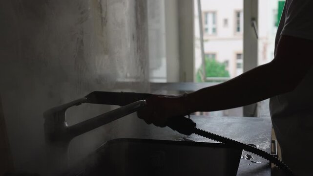 Steam vapor spreading across kitchen sink during deep cleaning process capturing hygiene, moisture and authentic modern household sanitation routine