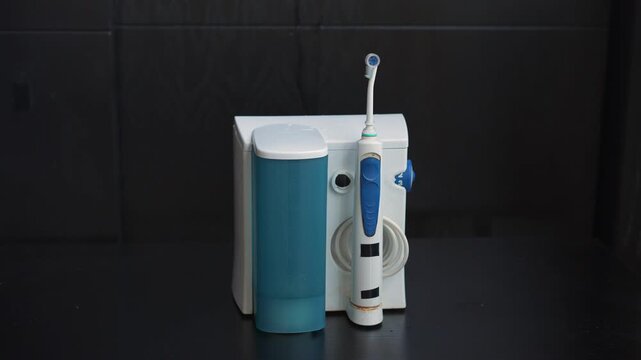 Dental water flosser working on a table. Uncompressed 24 bit audio. Oral hygiene technology, personal care and dental health concept.