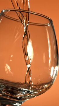 Cognac is poured into a glass. Filmed on a high-speed camera at 1000 fps. High quality FullHD footage