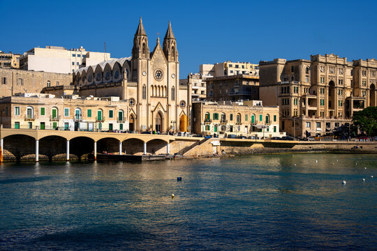 Neo Gothic Carmelite Church at Balluta Bay waterfront promenade in St Julians, Malta