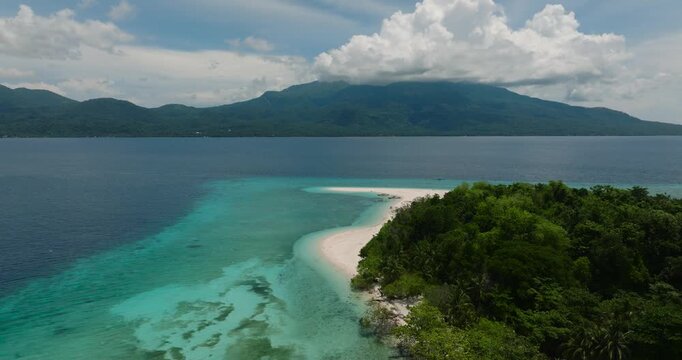 Natural beauty of Mantigue Island. Clear turquoise water and corals in atoll. Camiguin, Philippines.