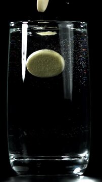 An aspirin tablet falls into a glass of water. Filmed on a high-speed camera at 1000 fps. High quality FullHD footage