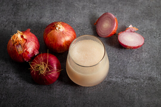 Fresh onion juice extracted from raw onions, rich in sulfur compounds, antioxidants, and nutrients, commonly used for haircare.