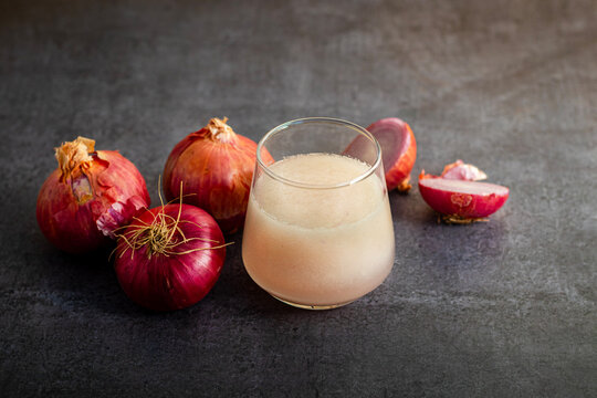 Fresh onion juice extracted from raw onions, rich in sulfur compounds, antioxidants, and nutrients, commonly used for haircare.