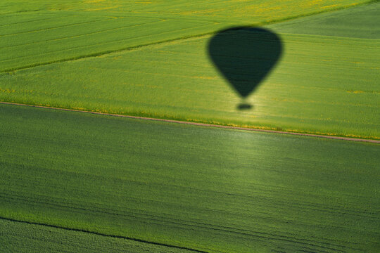 Hot air balloon ride. Aerial view on the field during sunset. Landscape from drone. Agricultural landscape from air.