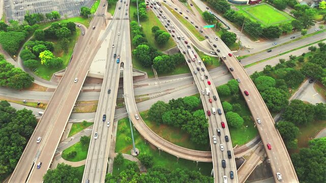 Descending drone view from Houston Texas skyline to layered freeway traffic