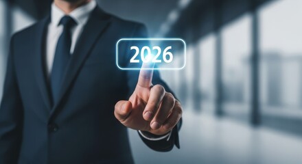 Obraz premium Man in Suit Pressing Holographic Digital Display Showing Year .