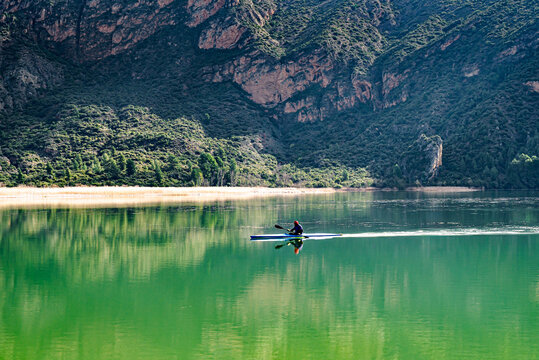 Man kayaking on the reservoir in the Sant Lloren&ccedil; de Montgai Natural Park, Noguera region, Lleida, Catalonia. Nature, water sports