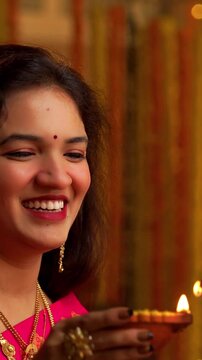 Couple Lighting Brass Oil Samai on Diwali , Indian Young Man and Woman in Traditional Kurta and Saree Smiling While Lighting Decorative Festival Lamp at Night Inside Cozy Ethnic Home Setting