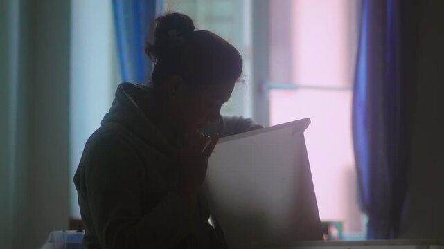 Woman lifting large storage container while searching for household items capturing organization, domestic routine and authentic everyday home life indoors
