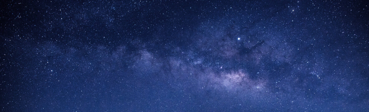 blue night sky milky way and star on dark background.with noise and grain.Photo by long exposure and select white balance.