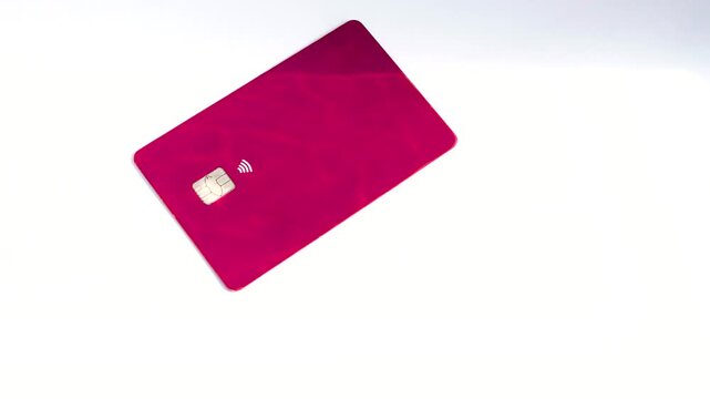 Credit card on a white surface, highlighting simplicity and elegance in financial transactions. Credit card on a white surface, emphasizing simplicity and versatility in transactions.