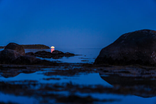 Moonrise near Vilm Island on R&uuml;gen with Large Boulder Stones in Foreground