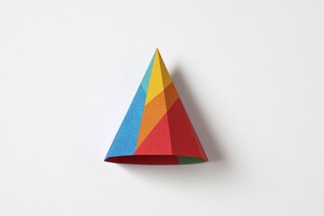 Fototapeta premium Colorful geometric paper party hat on white background