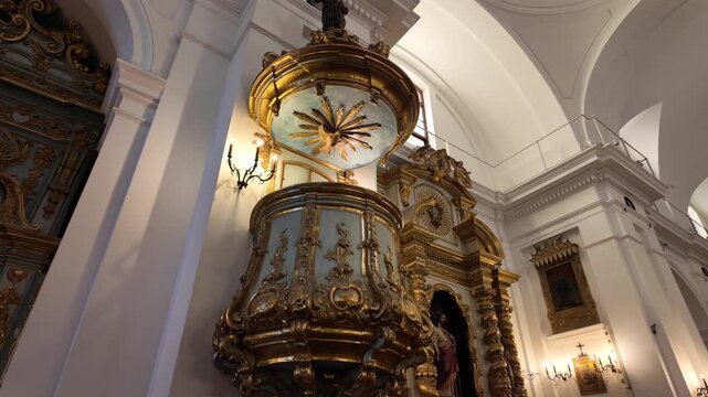 Ancient carved pulpit with gold and white details at the Pilar Basilica in Recoleta Buenos Aires Argentina.