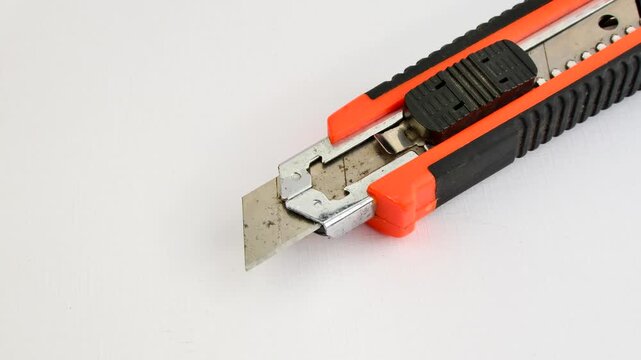Sharp utility knife on a clear surface, ready for precise cuts for creative projects. Close-up of a stylus on a light background, an essential tool for detailed work.