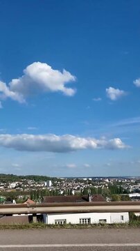 Unique perspective of the city of Nancy in northeastern France, captured through the side window of a moving car on the motorway. The urban skyline of this historic French city passes by 