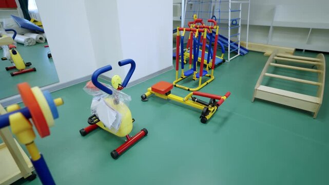 Miniature weightlifting bench sits ready for small athletes. Vibrant primary colors create cheerful and energetic environment in gym