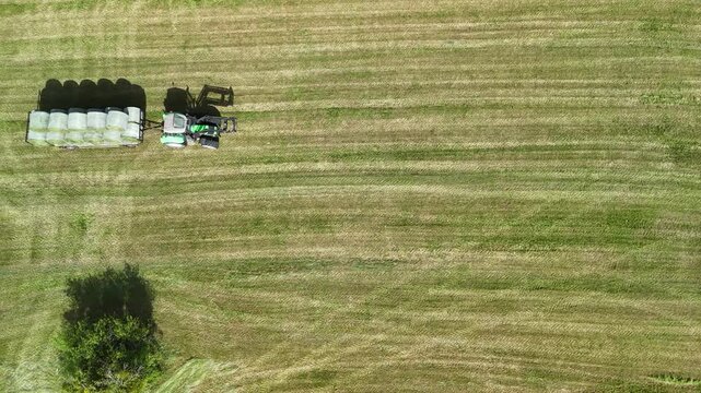 Aerial View of Tractor Working on Hay Field in Rural Countryside