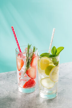 Two fresh non alcoholic drinks with strawberry and lemon on blue background
