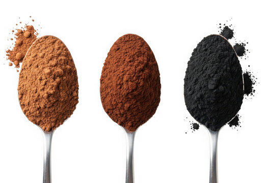 Three metal spoons with coffee and dark charcoal powder