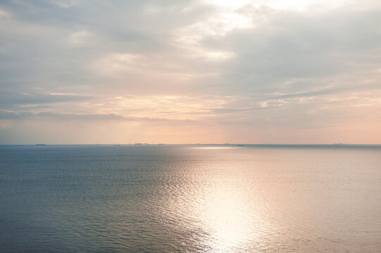 Golden seascape glows beneath overcast sky