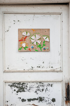 Rustic door features handmade mosaic artwork