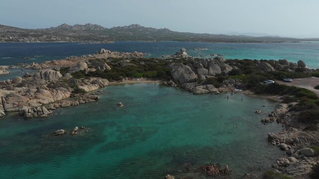 Stunning aerial view of the rocky coastline and turquoise sea of La Maddalena archipelago in Sardinia, Italy, on a beautiful summer day