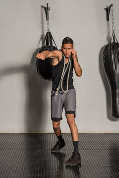 Young Hispanic boxer throwing left straight punch during warmup