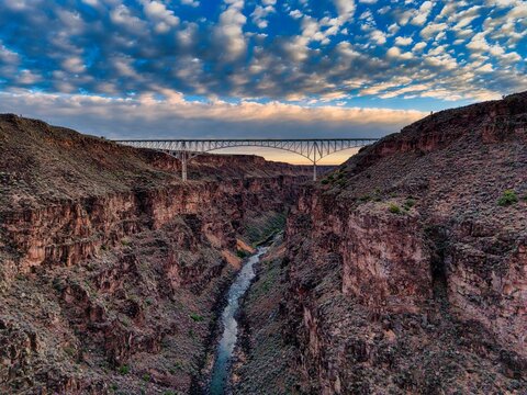 Aerial Sunset View of Rio Grande Gorge Bridge Over Canyon in Taos New Mexico