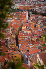 Naklejka premium Aerial panoramic view over the terracotta rooftops of the historic old town of Nice with the Mediterranean Sea in the background on a sunny day