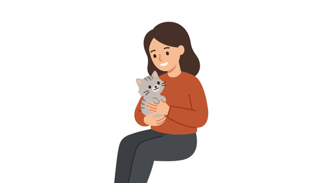 A young woman holding a small kitten with care.