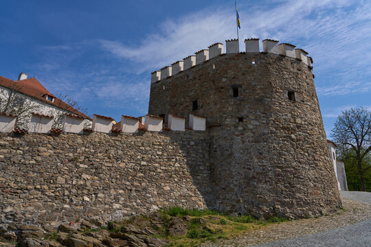 Pisek, Czech Republic - April 18, 2026 - Putim Gate. Ancient stone castle tower with crenellated battlements under a blue sky