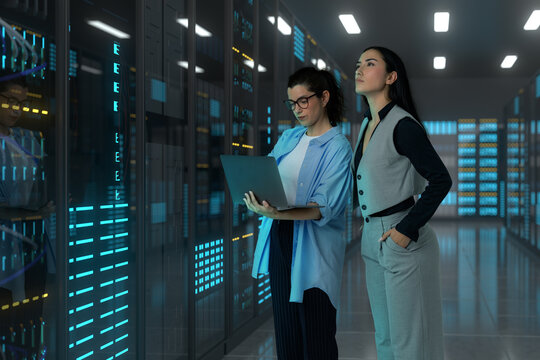 Women engineers monitoring server infrastructure in a 3D data center