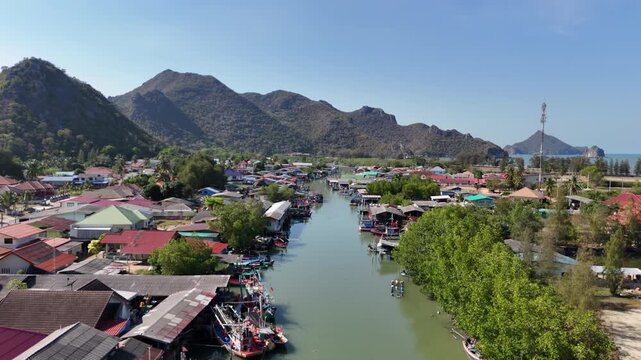 Aerial Drone View Of Coastal Fishing Village Thailand
Aerial drone footage of coastal fishing village near Thung Sam Roi Yot with mountains and boats in Thailand on 19 May 2026.
