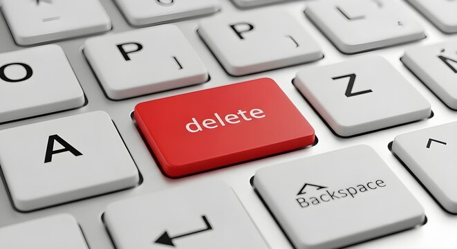 Close-up view of a vibrant red delete key standing out on a modern computer keyboard, symbolizing data removal and digital control