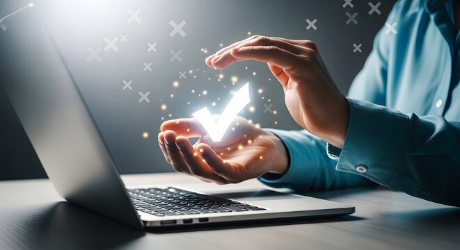 Person holding glowing white checkmark symbol above open laptop with glowing particles
