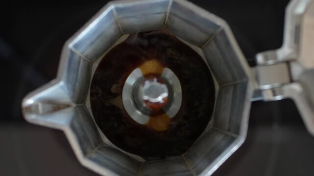 Close-up top view of moka pot filling in with coffee