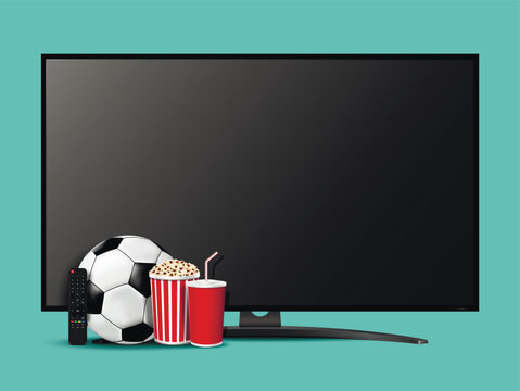 Modern smart television with remote control, pop corn, soda cup and soccer ball