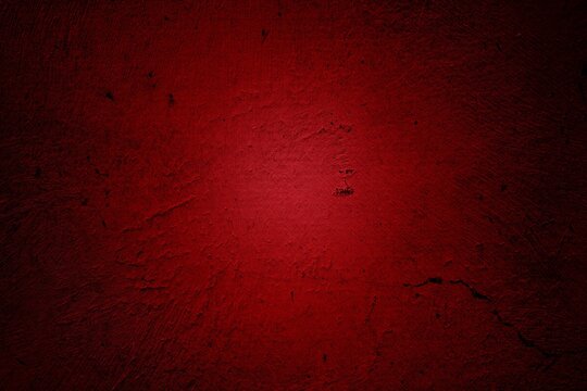 Dark red textured background with rough grunge finish. Ideal for dramatic backgrounds and intense designs.