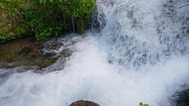 small waterfall of mountain river in the forest. Trout fishing. Ariege Pyrenees France