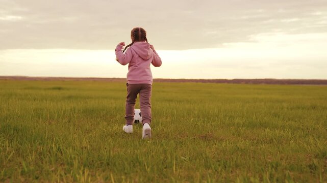 Innocent moments on the grass, Young athlete at sunset, Kid s passion for football, Outdoor life and fresh air, Childhood adventures in a field, Developing skills through play, Future football star