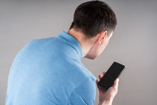 Man with neck pain from using smartphone, text neck and bad posture concept