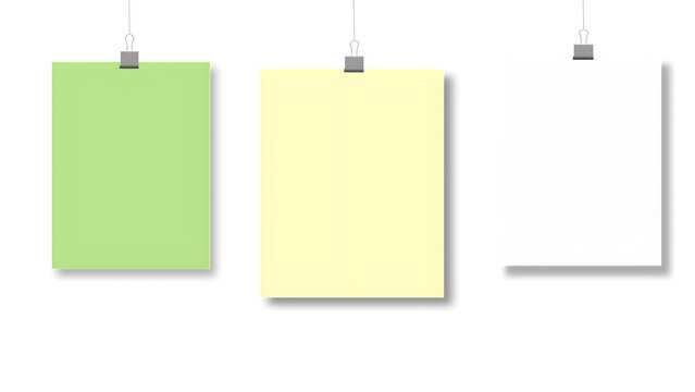 A collection of three blank colorful paper sheets hanging from metal binder clips with strings.